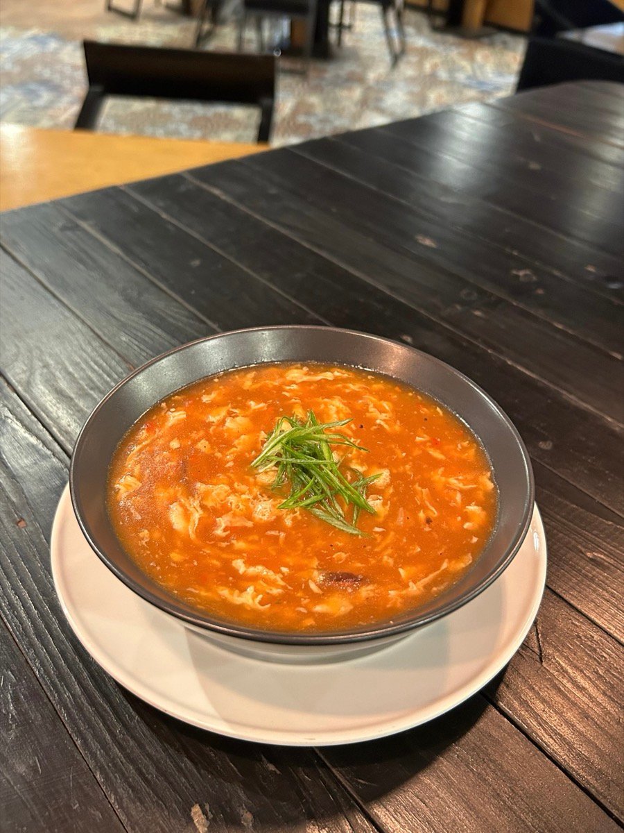 Hot and sour soup in a dark bowl