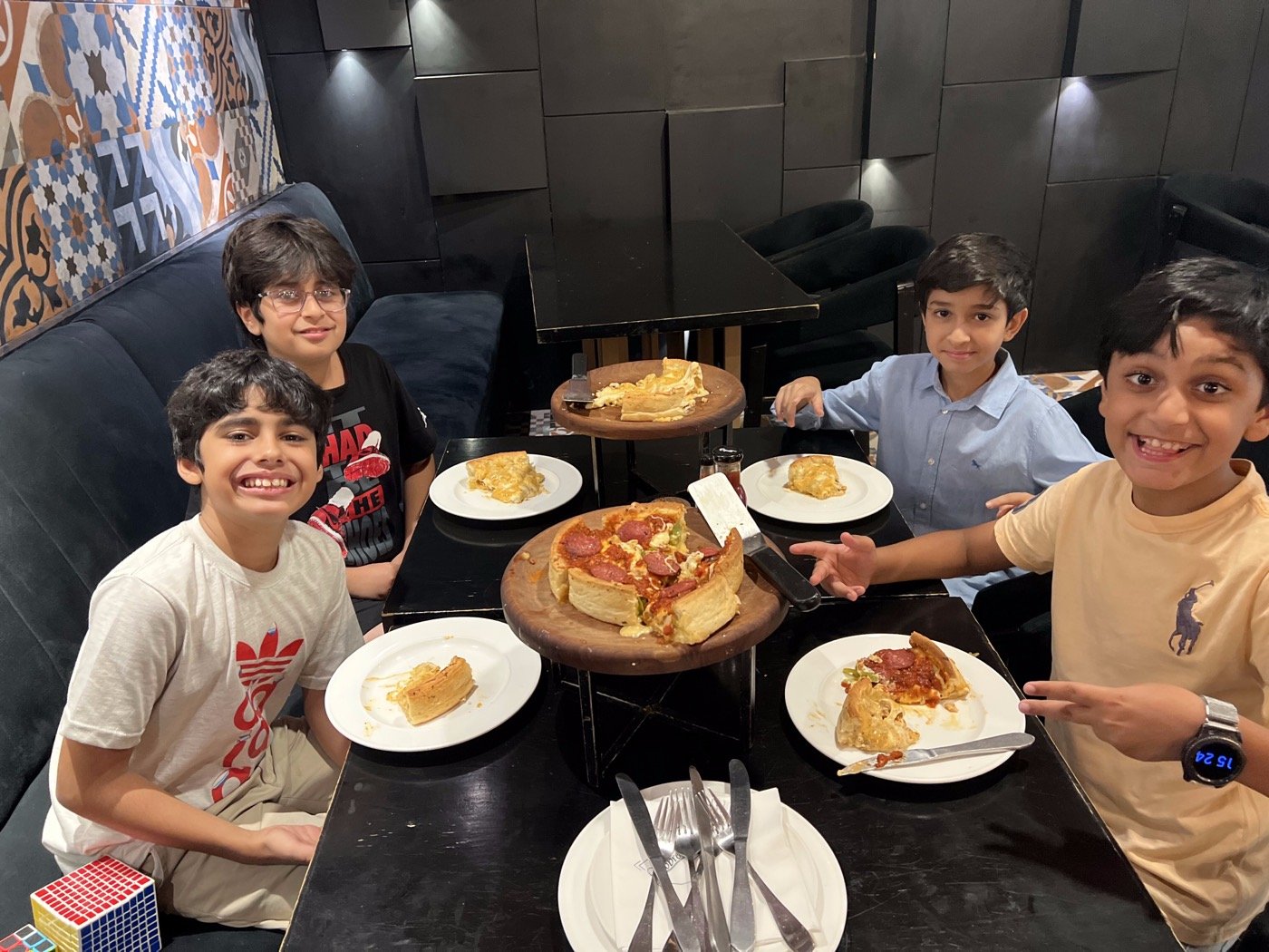 Children enjoying deep dish pizza together