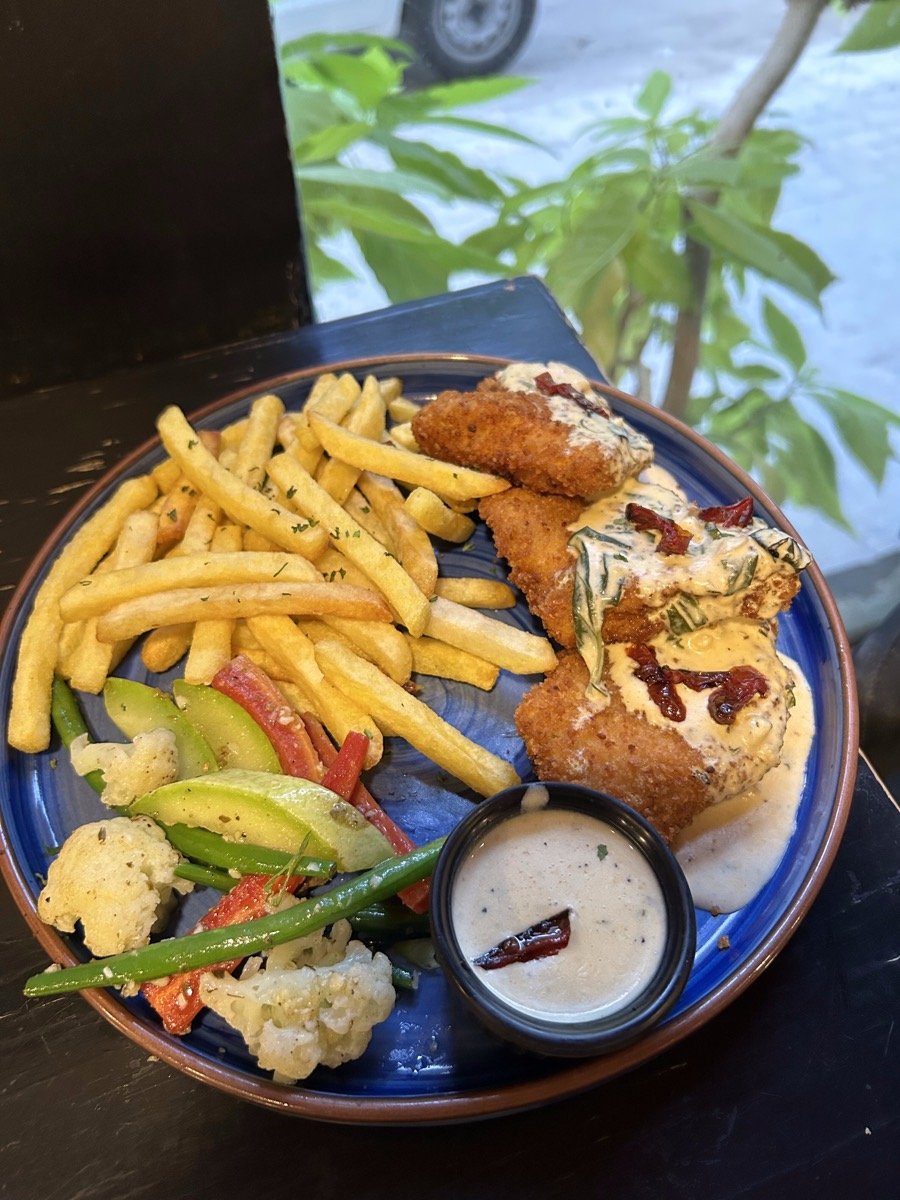 Parmesan crusted chicken with fries and vegetables